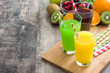 Fresh fruit smoothies on a rustic wooden tableの写真素材
