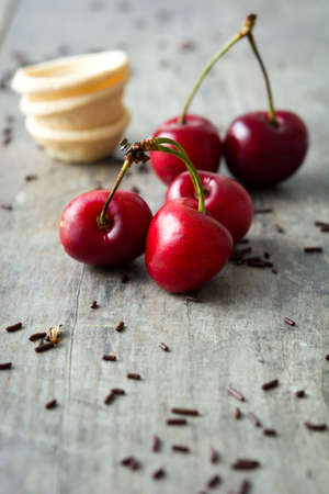 Delicious cherries on a rustic wooden tableの写真素材