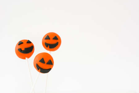 Halloween cake pops with pumpkin shape isolated on white backgroundの写真素材