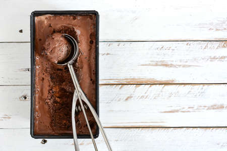 Chocolate ice cream on a white wooden backgroundの写真素材
