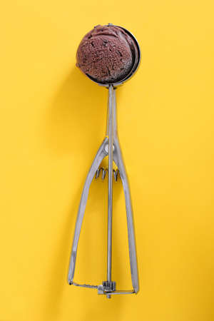 Chocolate ice cream on yellow background
