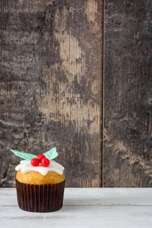 Christmas cupcake on a white wooden table and rustic wooden backgroundの写真素材