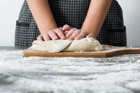 Woman making bread on wood
