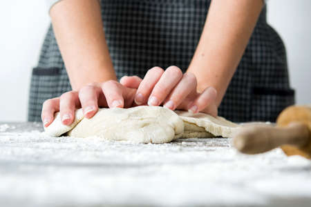 Woman making bread on wood