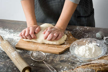 Woman making bread on woodの写真素材