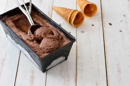 Chocolate ice cream on white wooden background
