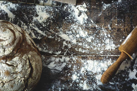 Bread and flour on a rustic wooden backgroundの写真素材