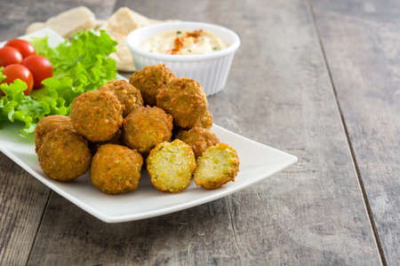Vegetarian falafels and hummus on a rustic wooden tableの写真素材