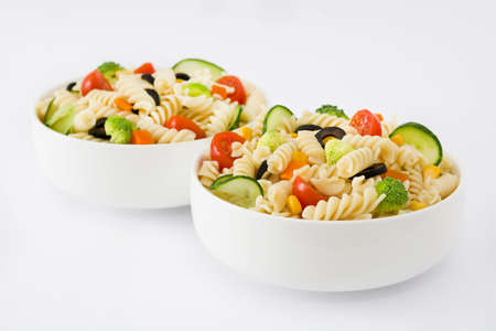 Pasta salad in a bowl isolated on white backgroundの写真素材