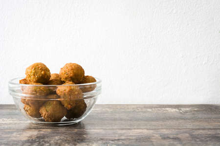Vegetarian falafels on rustic wooden table and white wallの写真素材