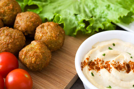 Falafels, hummus and lettuce on woodの写真素材