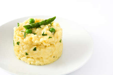 Risotto with peas, asparagus and parsley isolated on white backgroundの写真素材