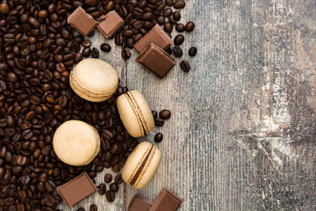 French coffee macaroons and chocolate on a rustic wooden backgroundの写真素材
