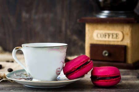 Coffee cup, macaroons and coffee grinderの写真素材
