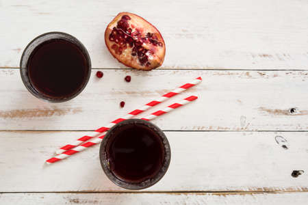 Pomegranate juice on a white wooden tableの写真素材