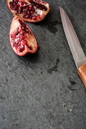 Pomegranate fruit on slate backgroundの写真素材