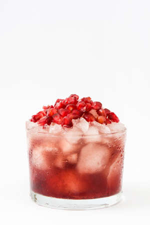 red with pomegranate cocktail and ice isolated on white backgroundの写真素材
