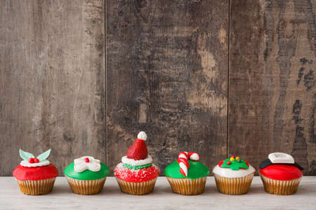 Christmas cupcakes on wooden backgroundの写真素材