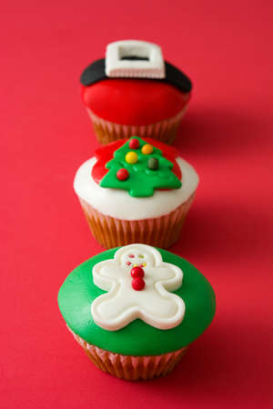 Christmas cupcakes on red backgroundの写真素材