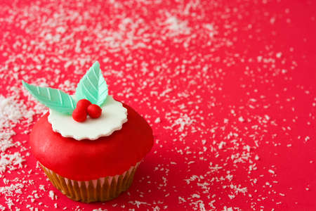 Christmas cupcake on red backgroundの写真素材