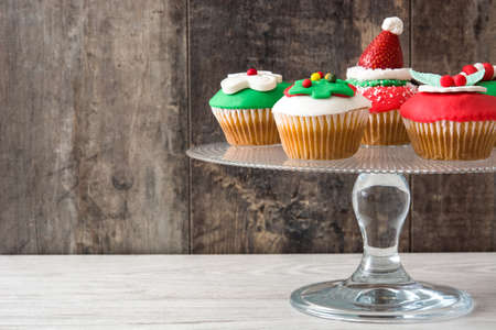 Christmas cupcakes on rustic wooden backgroundの写真素材