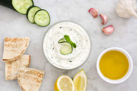 Tzatziki sauce in bowl on white marbleの写真素材
