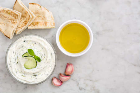 Tzatziki sauce in bowl on white marbleの写真素材