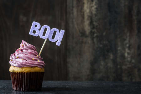 Halloween cupcake on rustic wooden backgroundの写真素材