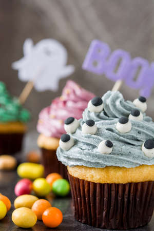 Halloween cupcakes on rustic wooden backgroundの写真素材