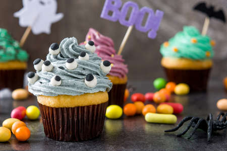 Halloween cupcakes on rustic wooden backgroundの写真素材