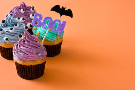 Halloween cupcakes on orange backgroundの写真素材