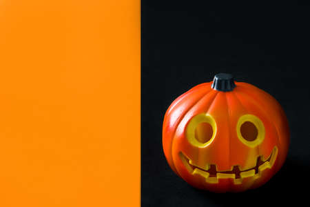 Halloween pumpkin on black and orange backgroundの写真素材