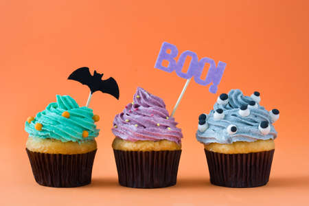 Halloween cupcakes on orange backgroundの写真素材