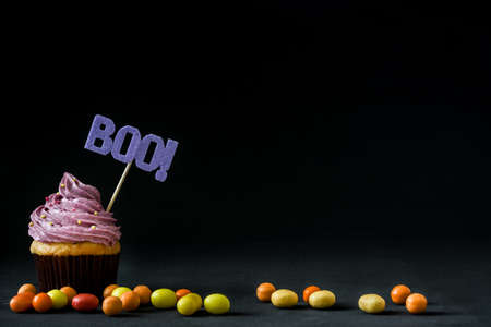 Halloween cupcake and candies on black backgroundの写真素材