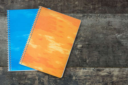 Two notebooks on wooden background