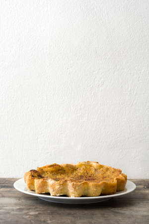 Homemade pumpkin pie on wooden backgroundの写真素材