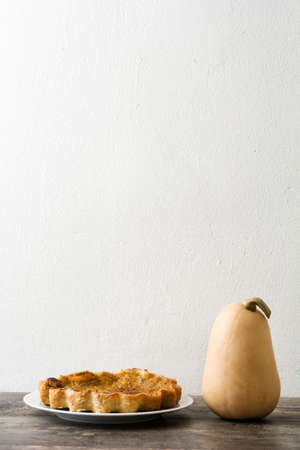 Homemade pumpkin pie on wooden backgroundの写真素材