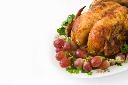 Garnished roasted turkey with grapes and herbsの写真素材
