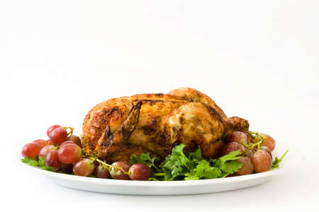 Garnished roasted turkey with grapes and herbsの写真素材