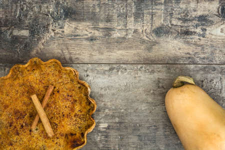Homemade pumpkin pie on wooden backgroundの写真素材