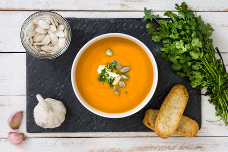 Pumpkin soup on a white wooden tableの写真素材