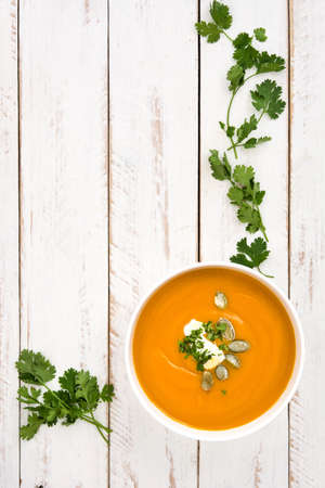 Pumpkin soup on a white wooden tableの写真素材