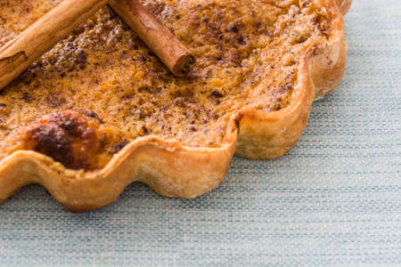 Homemade pumpkin pie on blue backgroundの写真素材