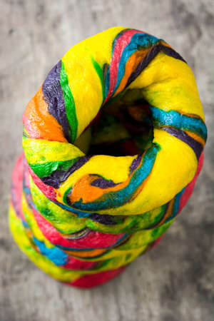 Colorful bagels on a wooden tableの写真素材