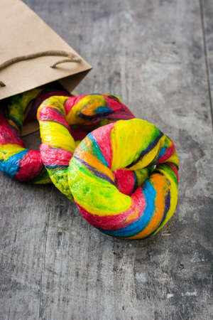 Colorful bagels on a wooden tableの写真素材