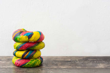 Colorful bagels on a wooden tableの写真素材