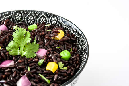 Black rice and vegetables in a bowl isolated on white backgroundの写真素材