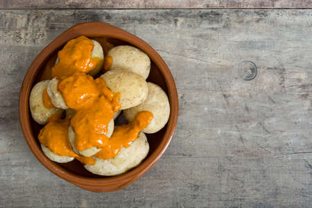 Canarian potatoes (boiled potatoes) With wet sauce on wooden tableの写真素材