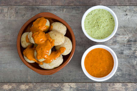 Canarian potatoes (boiled potatoes) With wet sauce on wooden table