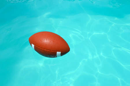 Rugby ball in a swimming poolの写真素材
